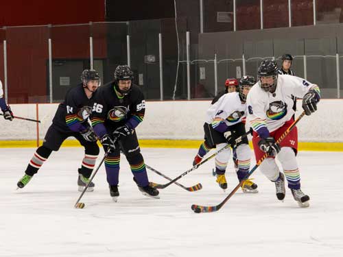 Hockey players chasing after puck